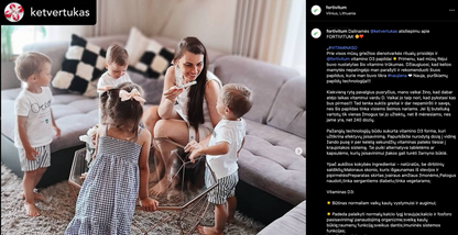 Woman sitting on a couch with four children in a living room.